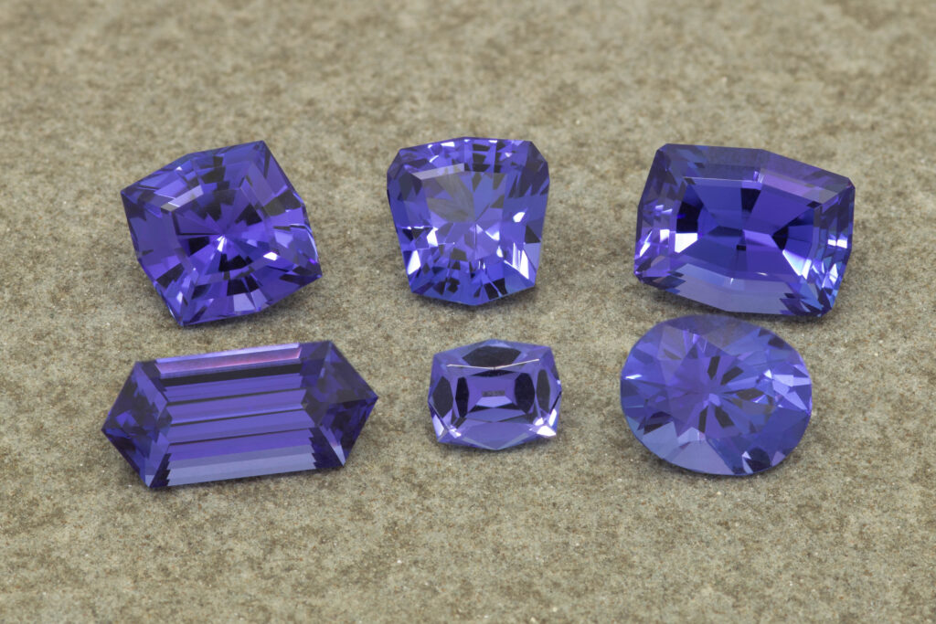 group of six finished tanzanite recovered from damaged stone