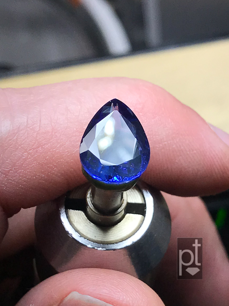 Tanzanite pear with scruffed up table, after repair